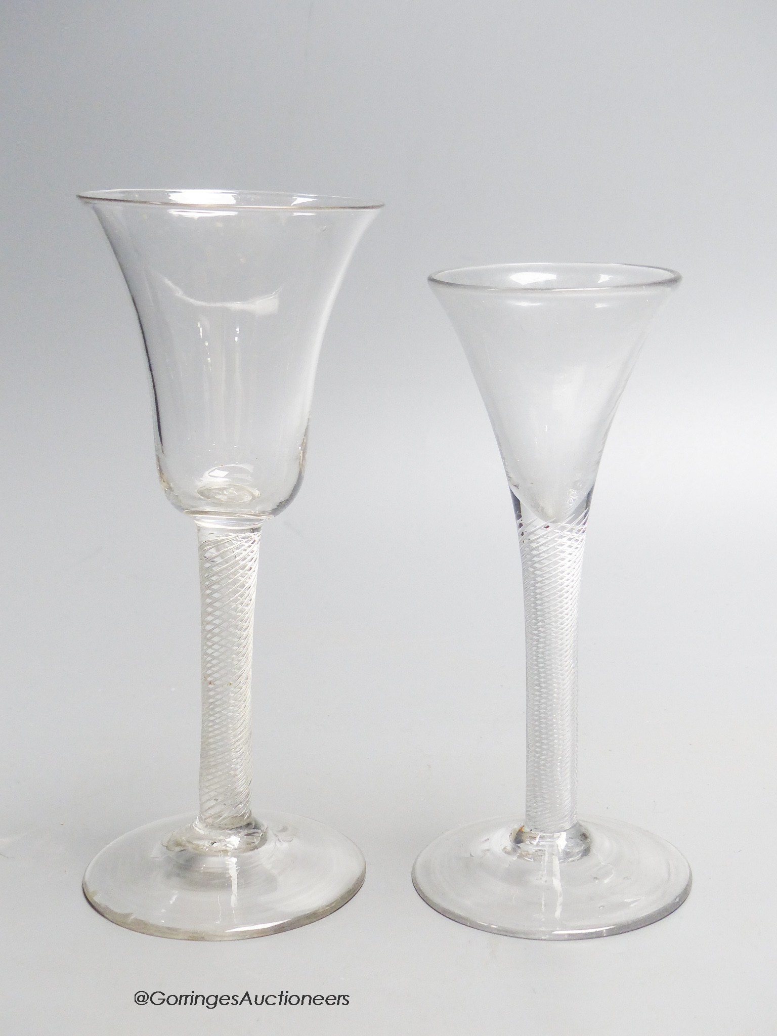 A Georgian air twist stem wine glass and an air twist stem drawn trumpet ale glass, c.1750, tallest 19cm